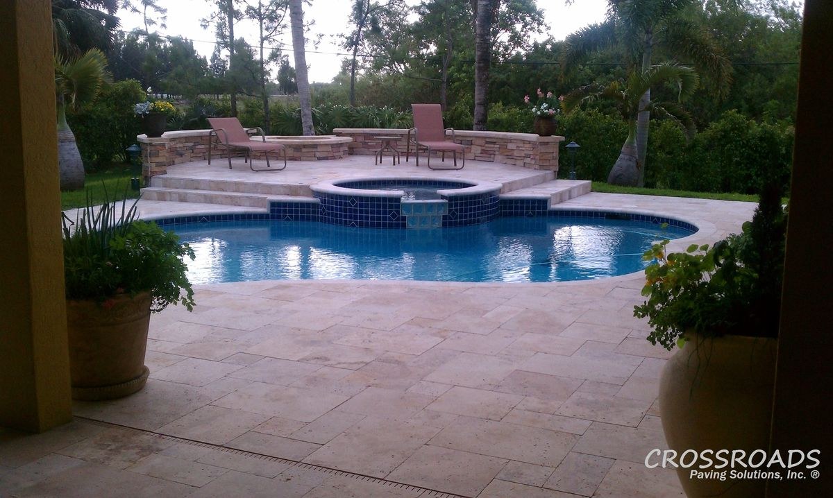 Paver pool deck installation with tumbled ivory pavers