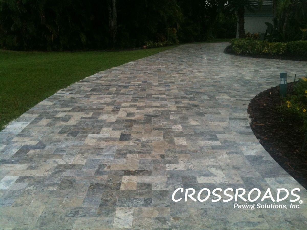 Paver driveway installation with silver travertine pavers