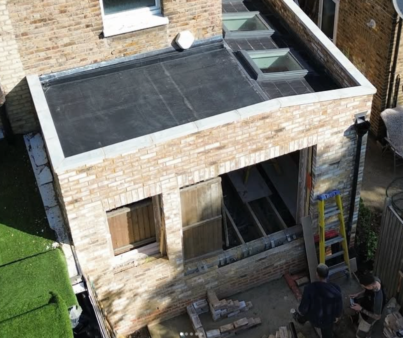 Completed brick rear extension with flat roof and rooflights