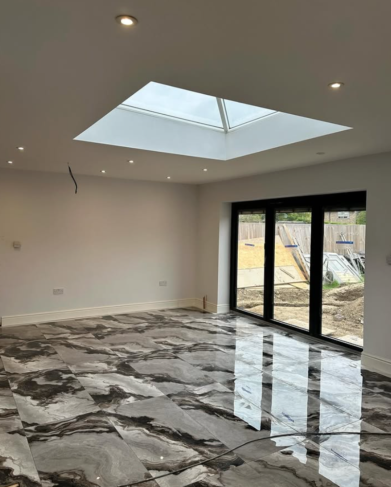 Finished marble floor with skylight and black framed doors