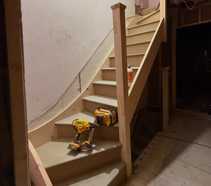 Curved timber stair installation during refurbishment